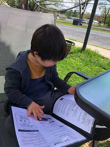 Alex checking out the menu at Lil Gus's